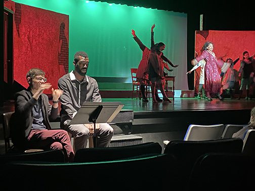 ASL interpreters sign beside the stage during a CTA performance