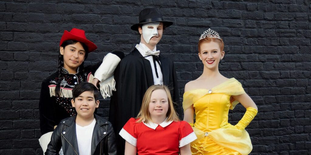 Costumed characters from Chesapeake Family's theater feature pose against a brick wall