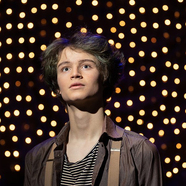 A performer as Peter looks up in wonder in CTA's Peter and the Starcatcher